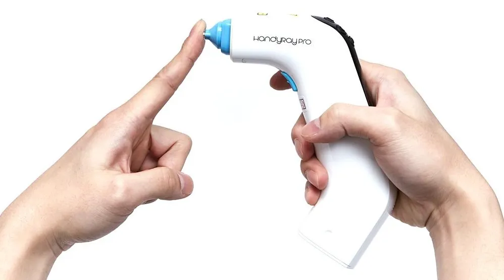 HandyRay-Pro in use: held to a fingertip for a near-painless laser lance